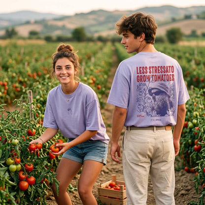 T-shirt Defeua Less Stress violetto indossata da due giovani in un campo di pomodori